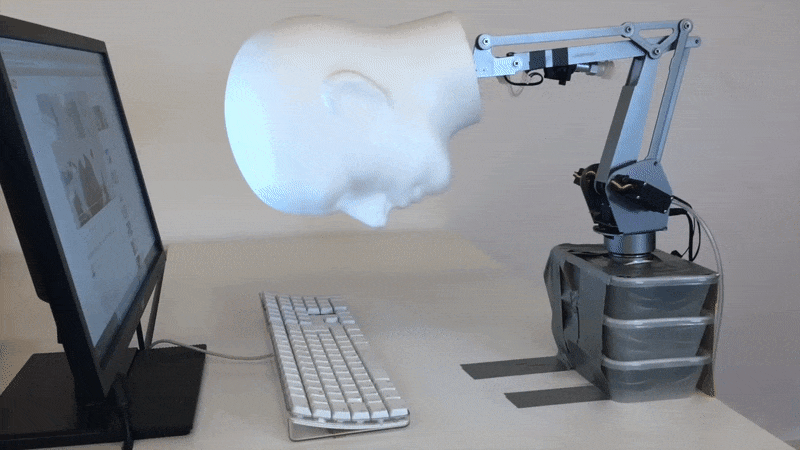 GIF of a robotic head mashing it's face against a keyboard